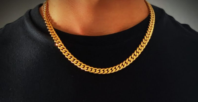 A man wearing a golden necklace
